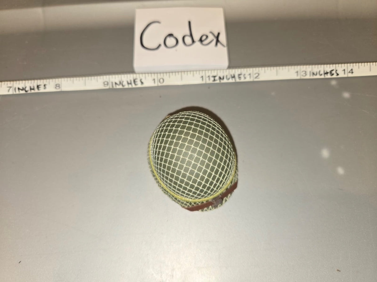 Using the ruler, the mesh screen dome is approximately 1.5 inches wide, consistent with a 1/6 scale microphone windscreen/mesh head. The tag reads "Codex." 1/6 Scale Modern Era Broadcast Microphone Mesh Windscreen - Codex